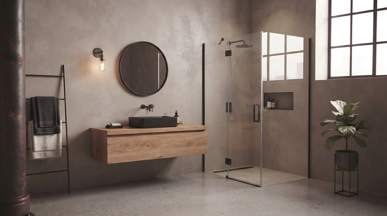 Clean bathroom vanity with a round mirror and plants